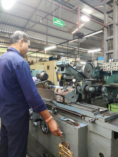 Operator turning a component on the workshop floor