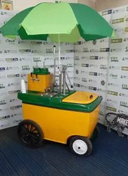 Yellow and green vending cart with umbrella